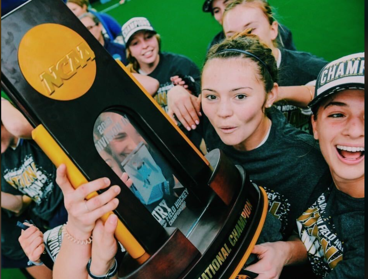 Team celebrating with NCAA championship trophy